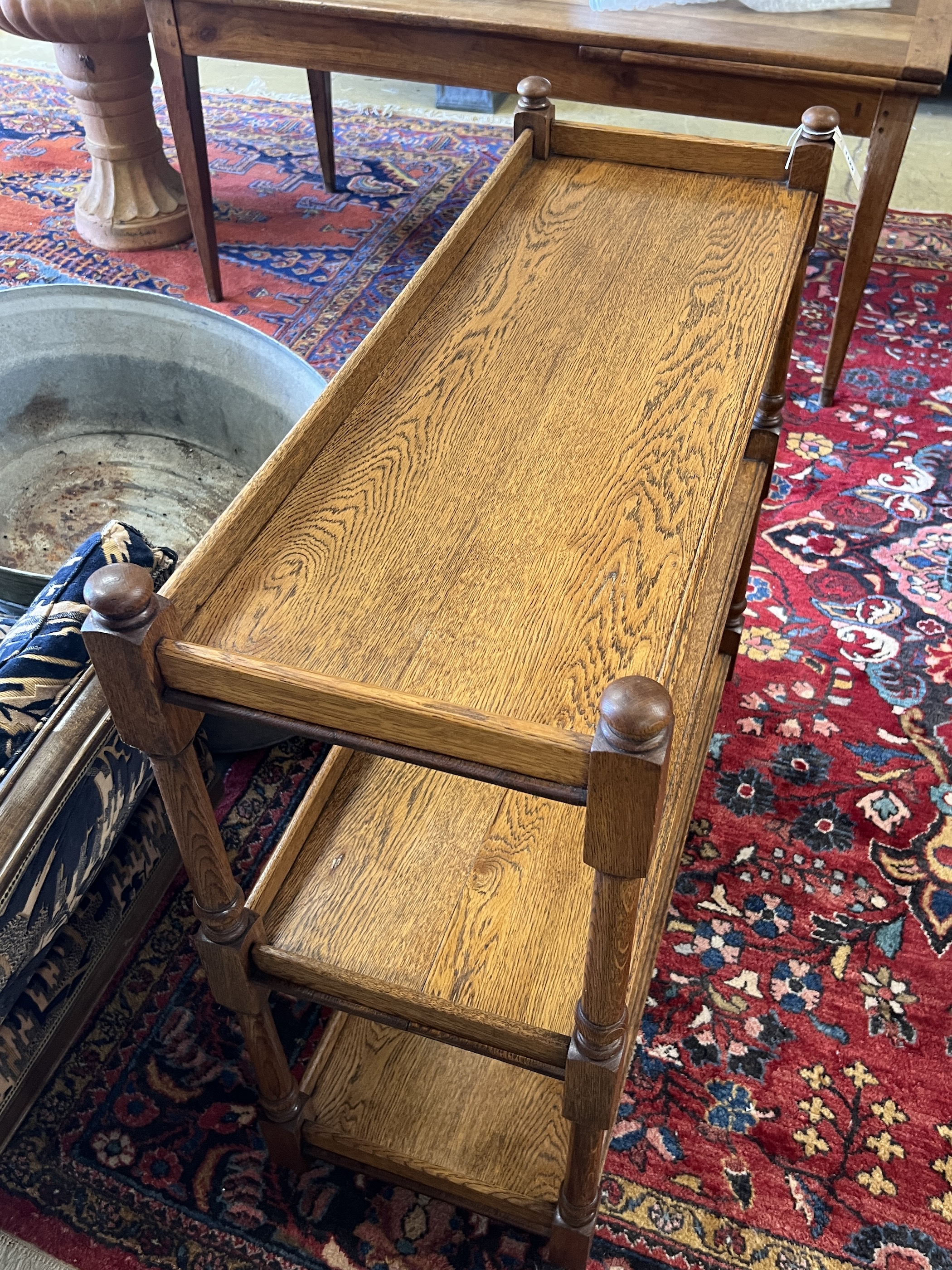 A late 19th / early 20th oak three tier buffet bears Jas Shoolbred & Co ivorine trade label, width 99cm, depth 38cm, height 95cm